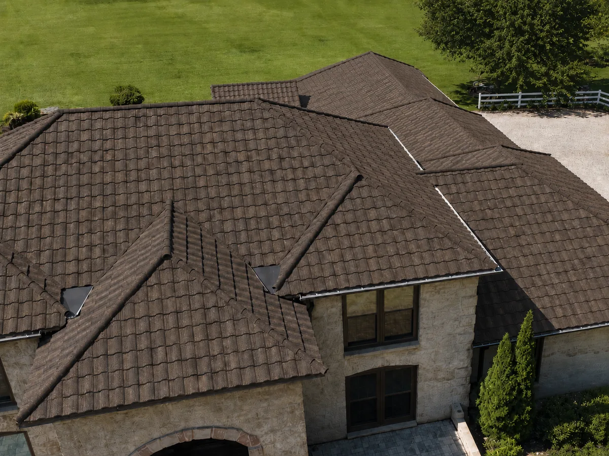 A stone-coated steel roof in a brown shake profile on a stone-clad home